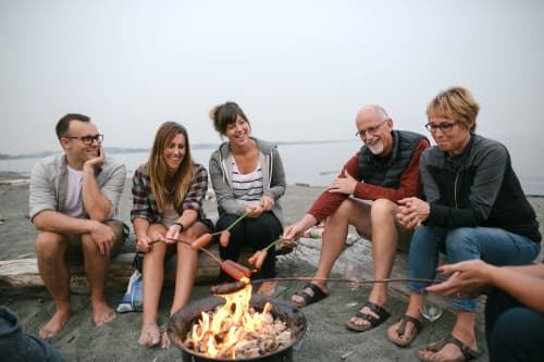 Multigenerational family cooking dinner on the beach