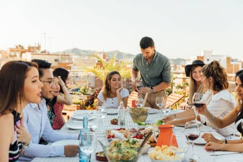 young adults toasting on balcony 