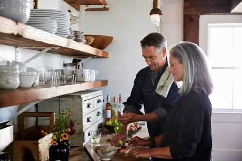 Older couple cooking a meal together