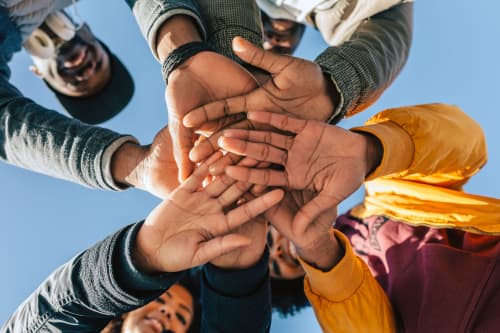 Group of friends stacking hands