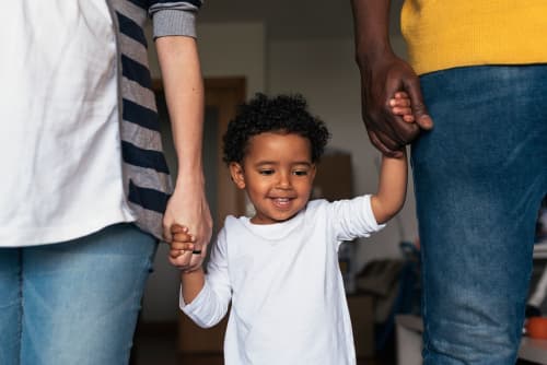 parents holding toddlers' hand