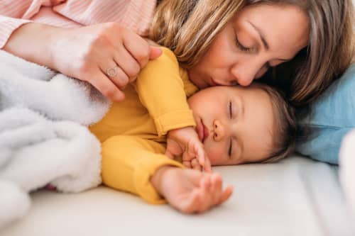 mother kissing baby