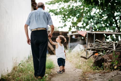 Grandfather and grandson walking