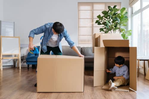 Father and son packing boxes