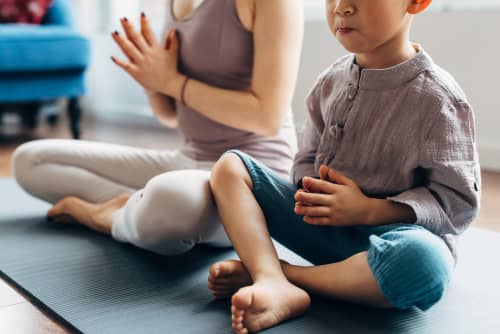 boy doing yoga with mom