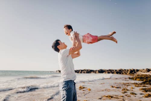 man and child on beach