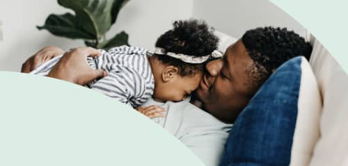 Dad hugging daughter on couch