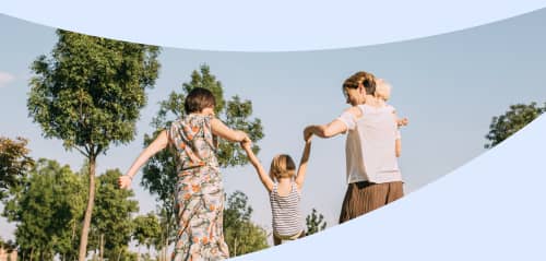 Two moms at a park with their kids