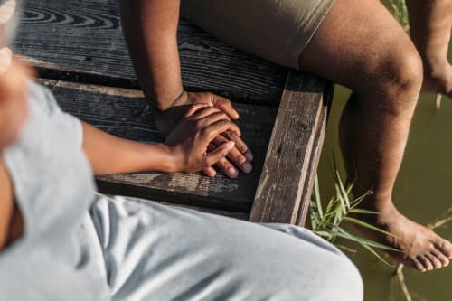 Couple holding hands on dock