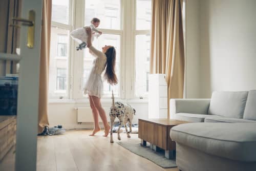 Woman lifting toddler in air