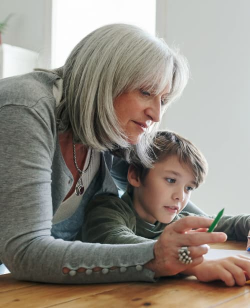 Kids Painting With Their Father And Grandmother At Home.