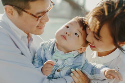 family holding toddler