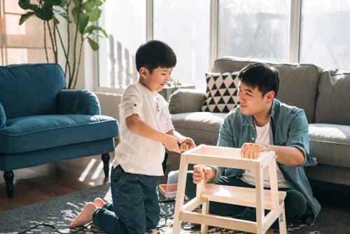 Dad and son building stool