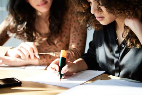 women-studying-and-taking-notes-together