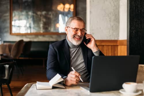 Man on phone with computer