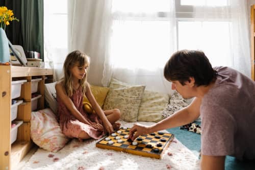 Dad and Daughter playing checkers