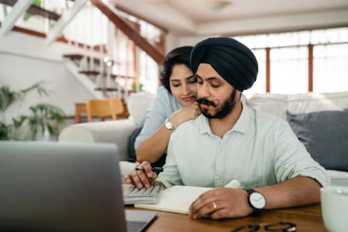 Husband and wife looking at laptop