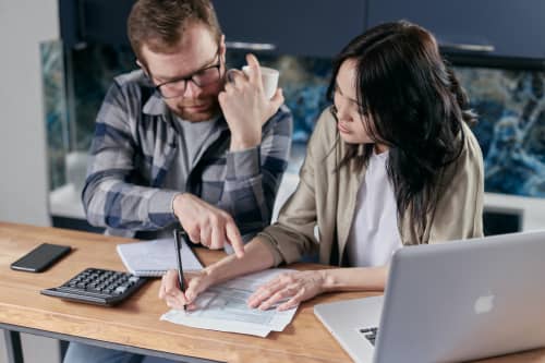 Man and woman working on laptop