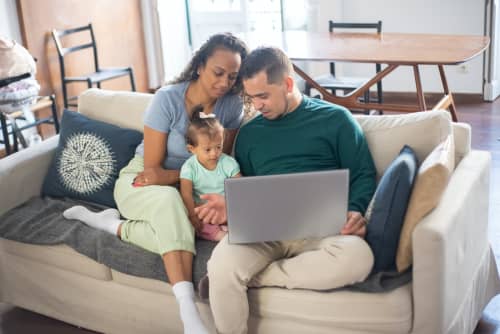 family sitting on couch together