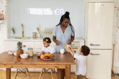 mother working in kitchen with kids