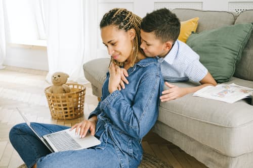 Mother and son looking at laptop