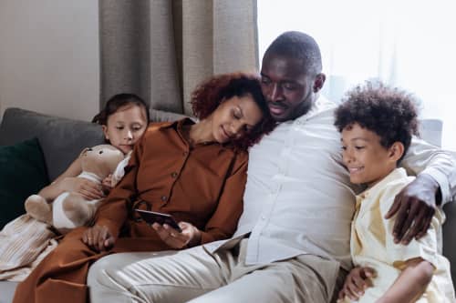 family sitting on couch together