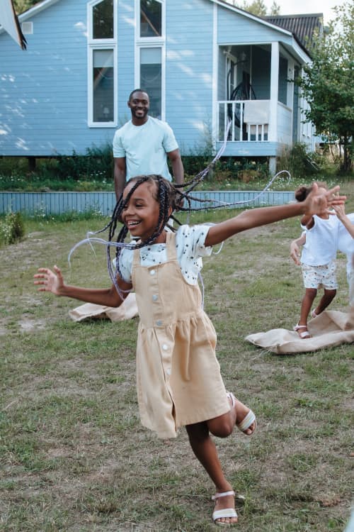 kids playing with dad in yard