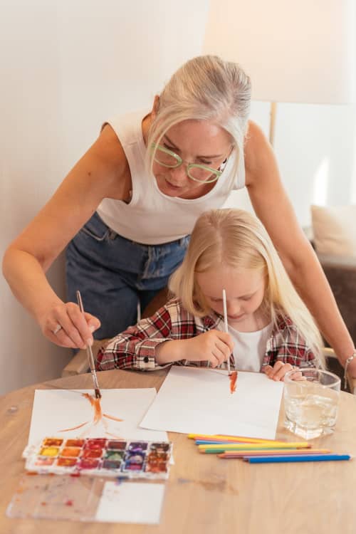 grandmother painting with grandchild