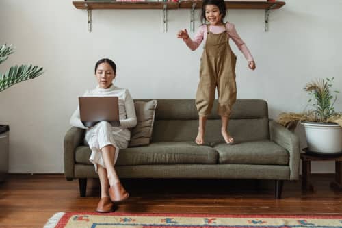 mother and daughter sitting on couch together