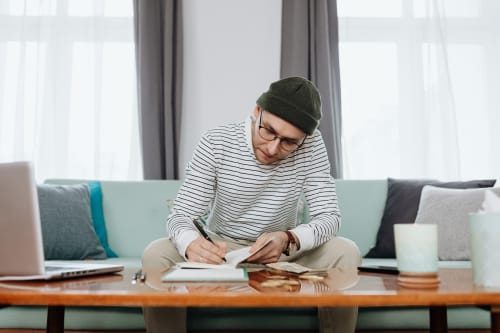 man journaling on couch