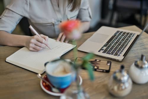 woman writing down notes