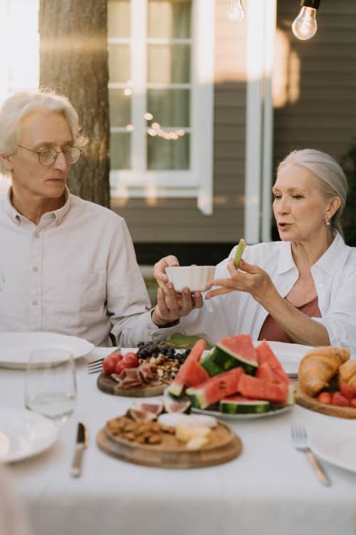 older couple enjoying dinner together outside