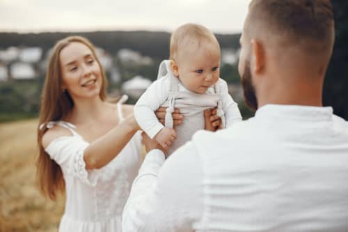 couple holding young baby 