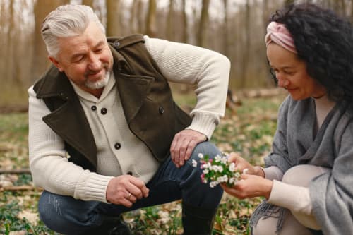 older couple picking flowers in yard