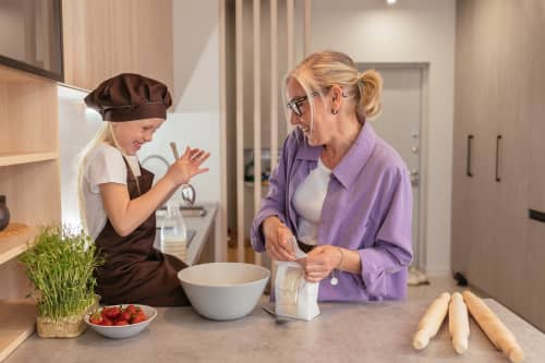 mom and daughter cooking together