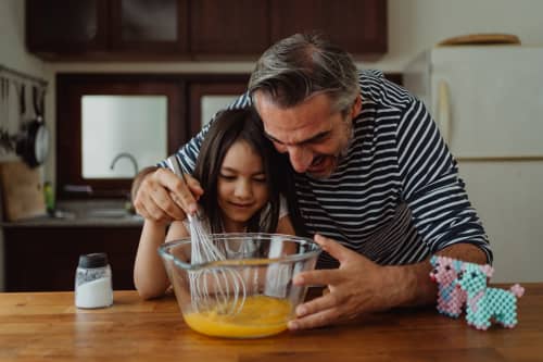 daughter and father cooking together