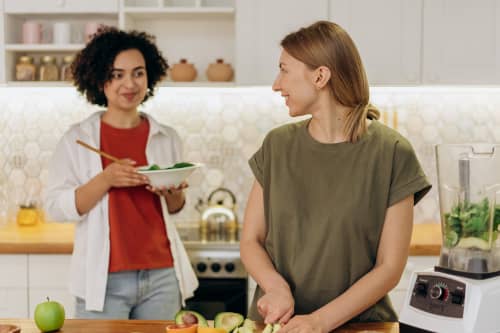 women in their 30s cooking in the kitchen together