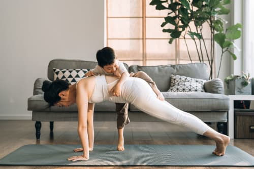 mother doing yoga with her kid