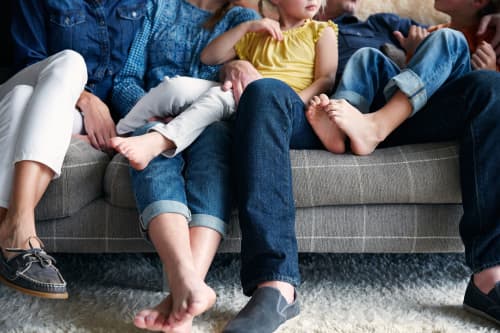 family sitting together on couch