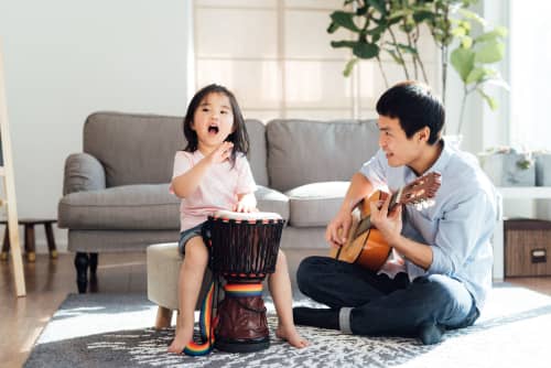 Father And Daughter Playing Musical Instruments