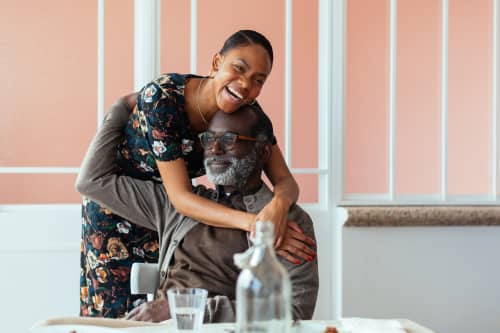 father and daughter laughing and hugging