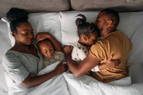 family laying in bed