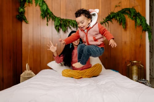 Child playing on bed