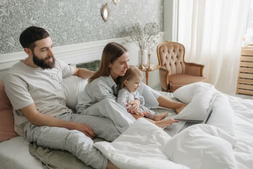 family laying in bed