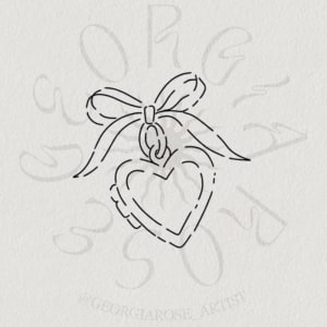 Image of love locket with bow (~3-5cm)