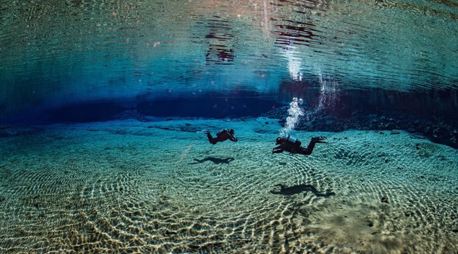 Divers in the Silfra Lagoon