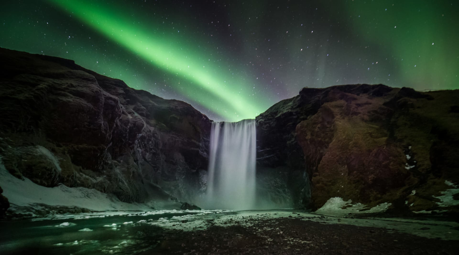 Beautiful northern lights over Skógarfoss waterfall Iceland