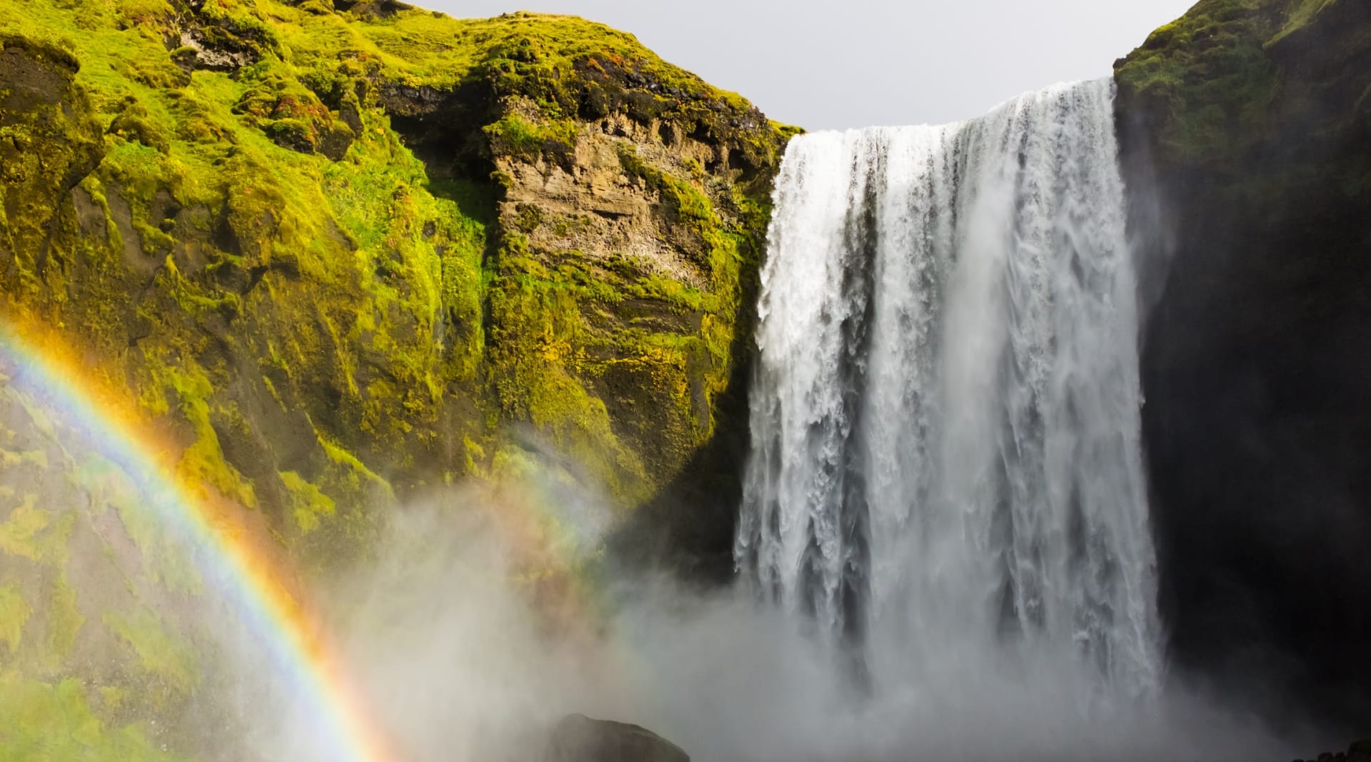 Skógarfoss waterfall decorated with magical rainbow