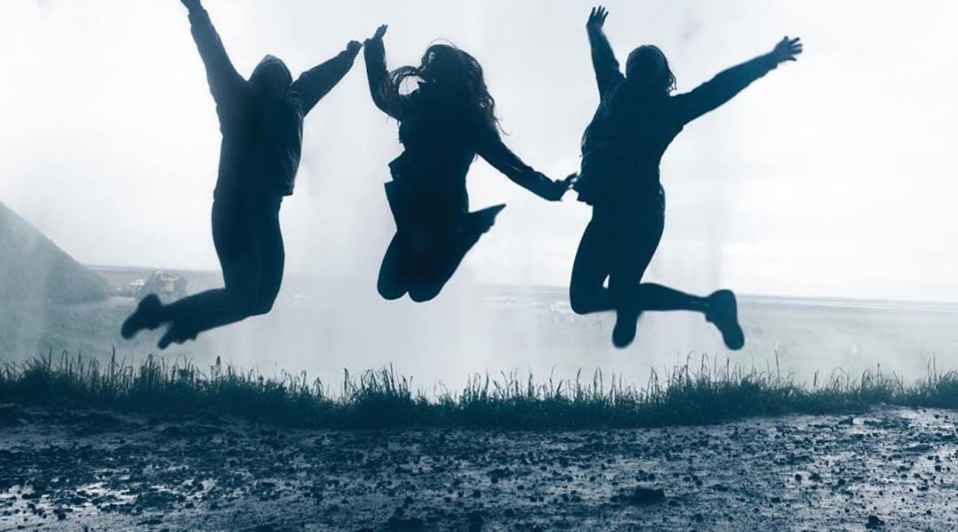 Jumping with joy behind Seljalandsfoss waterfall