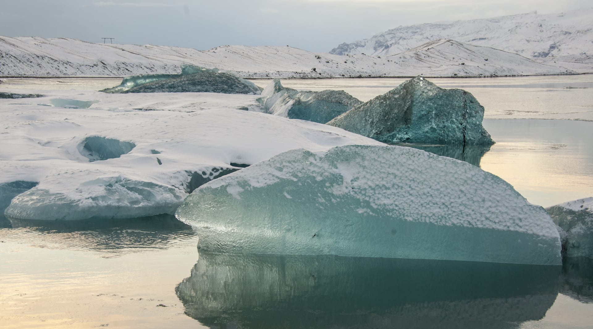 Marine green icebergs covered with fresh snow